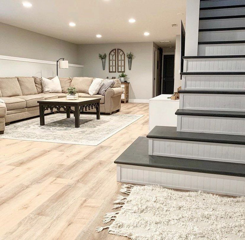 Staircase with dark grey treads and light grey painted risers in a living room.