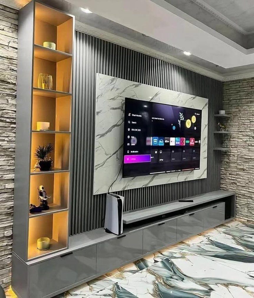 Modern TV wall with marble slab, grey vertical slats, and long floating console.